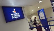In this file photograph taken on December 28, 2012, shows passengers as they the logo of the French customs (douanes) at Orly airport, south of Paris. AFP / Miguel Medina 