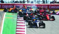 Valtteri Bottas driving the (77) Mercedes AMG Petronas F1 Team Mercedes W10 leads Max Verstappen of the Netherlands driving the (33) Aston Martin Red Bull Racing RB15 and the rest of the field into turn two at the start during the F1 Grand Prix of USA at 