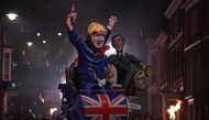 Effigies of Britain's Leader of the House of Commons Jacob Rees-Mogg (R) and Britain's Prime Minister Boris Johnson are paraded through the streets of Lewes in East Sussex, southern England, on November 5, 2019, during the traditional Bonfire Night celebr