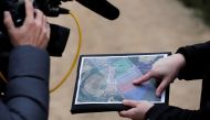 A member of the France's BEA aviation safety agency shows a map during a scour of an uninhabited wood to find pieces of the engine of a Swiss Air Lines Airbus A220 which fell from the aircraft mid-flight, in Perrigny-sur-Armancon, France, November 6, 2019