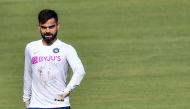 India's captain Virat Kohli walks jokingly during a training session ahead of the first test match between India and Bangladesh at Holkar Cricket Stadium in Indore on November 12, 2019. Gettyout/ AFP / Indranil MUKHERJEE /