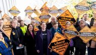 Britian's Liberal Democrats leader Jo Swinson (C) poses with supporters as she leaves Total Boxer, a boxing gym offering training to young people as a means of keeping them away from violence, campaigning for the general election in northeast London on No