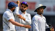 India's Mohammed Shami (L) talks with captain Virat Kohli (C) and teammate Mayank Agarwal looks on as they walk to the pavilion for lunch during the third day of the first Test cricket match of a two-match series between India and Bangladesh at Holkar Cri