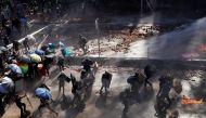 Protesters are sprayed with water from water cannon during clashes with police outside Hong Kong Polytechnic University (PolyU) in Hong Kong, China November 17, 2019. REUTERS/Thomas Peter