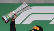 Brazilian Grand Prix race winner Red Bull’s Max Verstappen celebrates on the podium with the trophy at the Autodromo Jose Carlos Pace, Interlagos, Sao Paulo, Brazil. Reuters/Ricardo Moraes 
