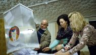 Local electoral commission members empty a ballot box to count votes at a polling station in the village of Kreva, some 10 km northwest of Minsk, on November 17, 2019. AFP / Sergei Gapon 