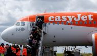 FILE PHOTO: Passengers board an easyJet plane at the Nantes-Atlantique airport in Bouguenais near Nantes, France, April 4, 2019. REUTERS/Stephane Mahe/File Photo