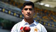 Pakistan's 16-year-old paceman Naseem Shah tosses the ball during a training session at Gabba in Brisbane on November 20, 2019, ahead of the first cricket Test match against Australia. / AFP / AFP / Saeed KHAN /