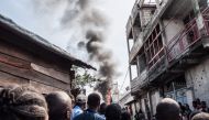 Residents react after a small aircraft carrying around 15 passengers crashed in a densely populated area in Goma on the East of the Democratic Republic of Congo on November 24, 2019. AFP / Pamela Tulizo 