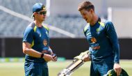Australian captain Tim Paine (L) chats with batsman Steve Smith (R) during a training session on the eve to the second cricket Test match between Australia and Pakistan in Adelaide on November 28, 2019. AFP / William West 