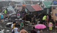 Residents stand among their damaged houses after Typhoon Kammuri hit Legazpi City, Albay, Philippines, December 2, 2019. REUTERS/Nino Luces