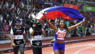 Kristina Marie Knott from the Philippines celebrates after winning in the women's 200m athletics event at the SEA Games (Southeast Asian Games) at the athletics stadium in Clark, Capas, Tarlac province north of Manila on December 7, 2019. / AFP / TED ALJI