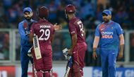 West Indies cricketer Lendl Simmons (R) and Nicholas Pooran (C) speak with Indian cricket captain Virat Kohli (L) after winning the second T20 international cricket match of a three-match series between India and West Indies at the Greenfield Internationa