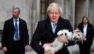 Boris Johnson holds his dog Dilyn as he leaves a polling station, at the Methodist Central Hall, after voting in the general election in London, Britain, December 12, 2019. Reuters/Dylan Martinez
