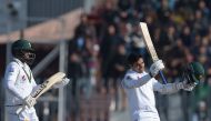 Pakistan's Abid Ali (R) celebrates after scoring half-century (50 runs) as his teammate Pakistan's Azhar Ali applauds during the fifth and final day of the first Test cricket match between Pakistan and Sri Lanka at the Rawalpindi Cricket Stadium in Rawalp