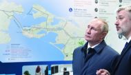Russian President Vladimir Putin (C) listens to Transport Minister Yevgeny Ditrikh after the opening ceremony of the railway part of the Crimean Bridge, connecting Crimea to mainland Russia in Taman on December 23, 2019. AFP / Sputnik / Alexey Nikolsky
