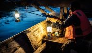 Representative image: A fisherman prepares lanterns to attract sardines after sunset for their overnight fishing at Lake Kivu, Kibuye, western Rwanda, on November 18, 2019. AFP / Simon Wohlfahrt 