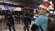 A man with a Santa hat stands in front of riot police during a protest in Mong Kok district in Hong Kong on December 25, 2019. AFP / Philip Fong
 
 
