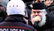 Serbian Orthodox Church clergy and believers stand in front of police near the parliament, ahead of the vote on a controversial law on religious freedom in Podgorica on December 26, 2019. AFP / Savo Prelevic
 