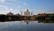 The Taj Mahal is reflected in a puddle in Agra, India August 9, 2016. REUTERS/Cathal McNaughton/File Photo