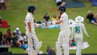 England's Joe Denly (L) and England's Joe Root (R) greet each other during the fourth day of the first Test cricket match between South Africa and England at The SuperSport Park stadium at Centurion near Pretoria on December 29, 2019. / AFP / MARCO LONGAR