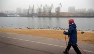 A woman walks along the Channel of Moscow in Moscow on December 26, 2019. Winters in Moscow usually look like something out of a picture book: the Russian capital is covered in snow, people go skiing, and temperatures are well below freezing.   AFP / Alex