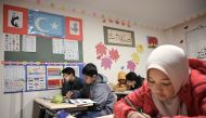 Uighur childen attend a science lesson in a school of Silivri district in Istanbul on November 29, 2019. AFP / Ozan Kose 