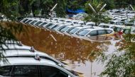 A fleet of flooded taxis are seen at the operator's submerged parking lot following overnight rain in Jakarta on January 1, 2020. Nine people died after Indonesia's capital was hit by its deadliest flooding in years, authorities said January 1, as torrent