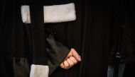 A lawyer closes his fist during a demonstration of lawyers against the French government's plan to overhaul the country's retirement system, on January 6, 2020 in Lyon, central eastern France. AFP / Jean-Philippe Ksiazek