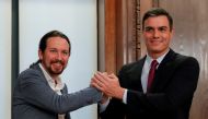 Spain's acting Prime Minister Pedro Sanchez and Unidas Podemos (Together We Can) leader Pablo Iglesias shake hands as they present their coalition agreement at Spain's Parliament in Madrid, Spain, December 30, 2019. Reuters/Susana Vera