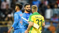 India's Virat Kohli (L) greets Australia's David Warner after the Australian team won the first one day international (ODI) cricket match of a three-match series between India and Australia at the Wankhede Stadium in Mumbai on January 14, 2020.  AFP / Pun