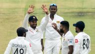 Sri Lanka's captain Dimuth Karunaratne (2ndL) celebrates with teammates after the dismissal of Zimbabwe's Kevin Kasuza during the first day of the first Test cricket match between Zimbabwe and Sri Lanka at the Harare Sports Club in Harare on January 19, 2