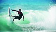 In this file photo taken on October 01, 2019 a surfer makes a turn as he rides the wave in the ocean at Omaezaki on. AFP / Adrian Dennis