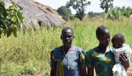 Pyerina Adong Otto (left) and family at her home in Awach, Uganda, December 5, 2019. Thomson Reuters Foundation/Liam Taylor