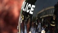 Albanian policemen are reflected in the helmet of a riot policeman in Tirana, Albania, May 19, 2011. Reuters/Arben Celi