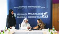Eisa Ahmed Abdulla (sitting, left), Chief Operating Officer and Managing Director, Corporate Services of the Regulatory Authority and Dr Amal Mohammed Al Malki, Founding Dean, College of Humanities and Social Sciences, Hamad Bin Khalifa University, exchan