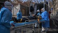 Medical staff in protective clothes are seen carrying a patient from an apartment suspected of having the virus in Wuhan, in Hubei province on January 30, 2020. AFP / Hector Retamal 