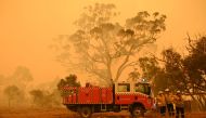 Firefighters protect property from bushfires burning near the town of Bumbalong south of Canberra on February 1, 2020. AFP / PETER PARKS