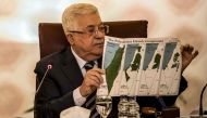 Palestinian president Mahmud Abbas holds a placard showing maps of (L to R) historical Palestine, the 1947 United Nations partition plan on Palestine, the 1948-1967 borders between the Palestinian territories and Israel, and a current map of the Palestini