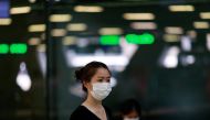 FILE PHOTO: A tourist wears a mask to prevent the spread of the new coronavirus as she arrives at the Suvarnabhumi Airport in Bangkok, Thailand February 3, 2020. REUTERS/Soe Zeya Tun/File Photo