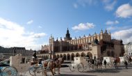 Horse carriages stand near the Cloth Hall building in the old city center in Krakow on Febuary 5, 2020. AFP / Ludovic Marin
 