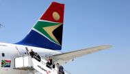 FILE PHOTO: Passengers board a South African Airways plane at the Port Elizabeth International Airport in the Eastern Cape province, South Africa, September 30, 2018. REUTERS/Siphiwe Sibeko/File Photo