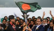 Bangladesh's Cricket Board President Nazmul Hasan Papon (R) and Bangladesh's Under-19 cricket team captain Akbar Ali (L) hold the International Cricket Council (ICC) Under-19 World Cup trophy during a reception ceremony in the Sher-e-Bangla National Crick