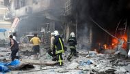 Fire fighters extinguish a fire which broken out after Russian forces staged air-strike over residential areas in Tariq al-Bab neighborhood of Aleppo, Syria, on April 23, 2016. Anadolu Agency / ?brahim Ebu Leys