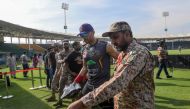 A ranger (R) escorts Quetta Gladiators' Tymal Mills (2R) of England as he leaves the ground after a practice session for the upcoming 2020 Pakistan Super League (PSL) at National Stadium in Karachi on February 18, 2020. The Pakistan Super League (PSL) 202