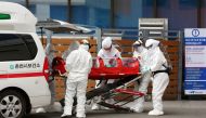 A confirmed coronavirus patient is wheeled to a hospital at Chuncheon, South Korea, February 22, 2020. Yonhap via REUTERS
