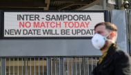 A man wearing a face mask stands outside the San Siro stadium after the Inter Milan v Sampdoria Serie A match was cancelled due to an outbreak of the coronavirus in Lombardy and Veneto, in Milan, Italy, February 23, 2020. Reuters/Daniele Mascolo