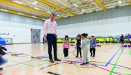 Young kids receive golf tips from an instructor at the Education City Golf Club. 