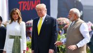 India's Prime Minister Narendra Modi (R) speaks with US President Donald Trump (C) and First Lady Melania Trump (L) upon their arrival at Sardar Vallabhbhai Patel International Airport in Ahmedabad on February 24, 2020. / AFP / Mandel NGAN 