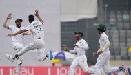Bangladesh's Nayeem Hasan (2R) celebrates with teammates Ebadot Hossain (L) after the dismissal of the Zimbabwe's Donald Tiripano during the third day of a Test cricket match between Bangladesh and Zimbabwe at the Sher-e-Bangla National Cricket Stadium in